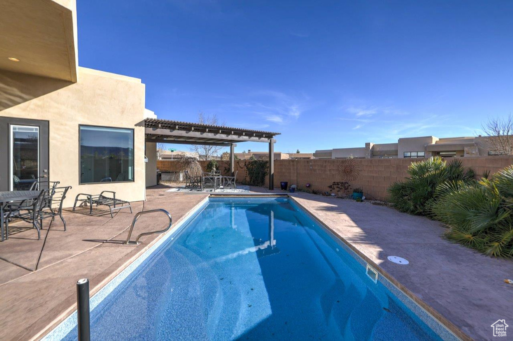 View of swimming pool featuring a pergola and a patio area