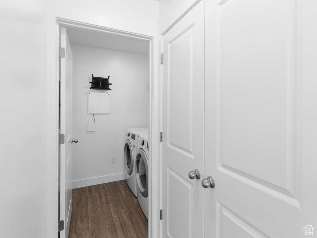 Laundry area featuring dark hardwood / wood-style flooring and separate washer and dryer
