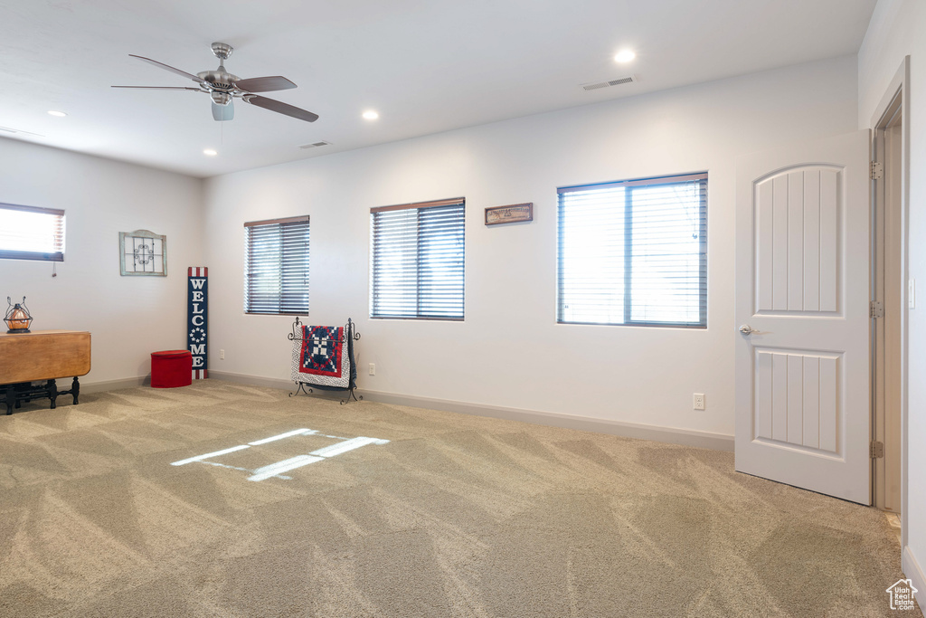 Miscellaneous room with light carpet and ceiling fan