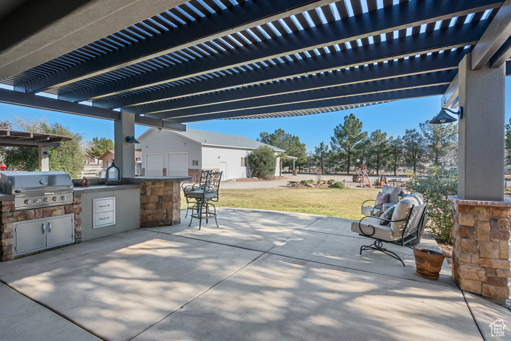View of patio / terrace featuring an outdoor kitchen, a grill, and a pergola