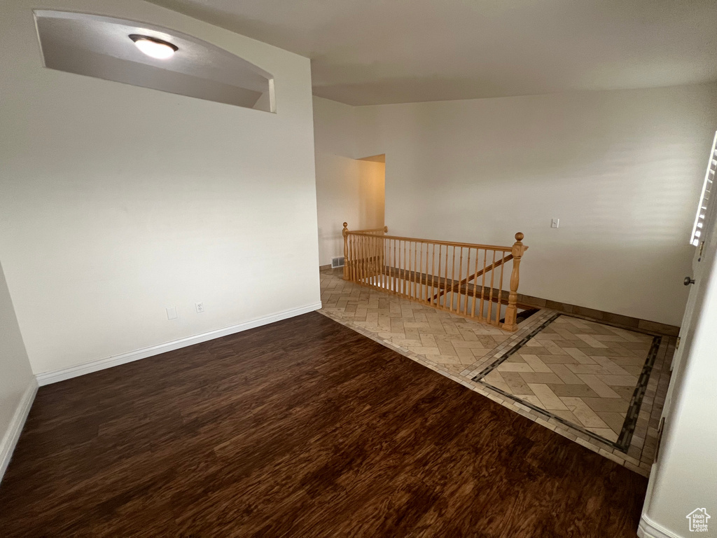 Empty room with dark hardwood / wood-style floors