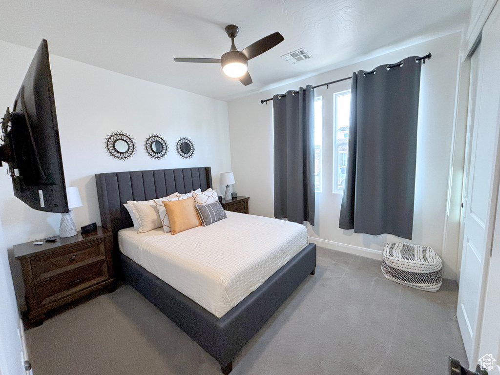 Bedroom featuring a closet, ceiling fan, and carpet