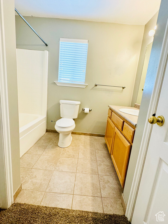 Full bathroom featuring shower / bathtub combination, vanity, tile flooring, and toilet