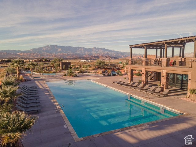 View of pool featuring a mountain view, a pergola, and a patio area