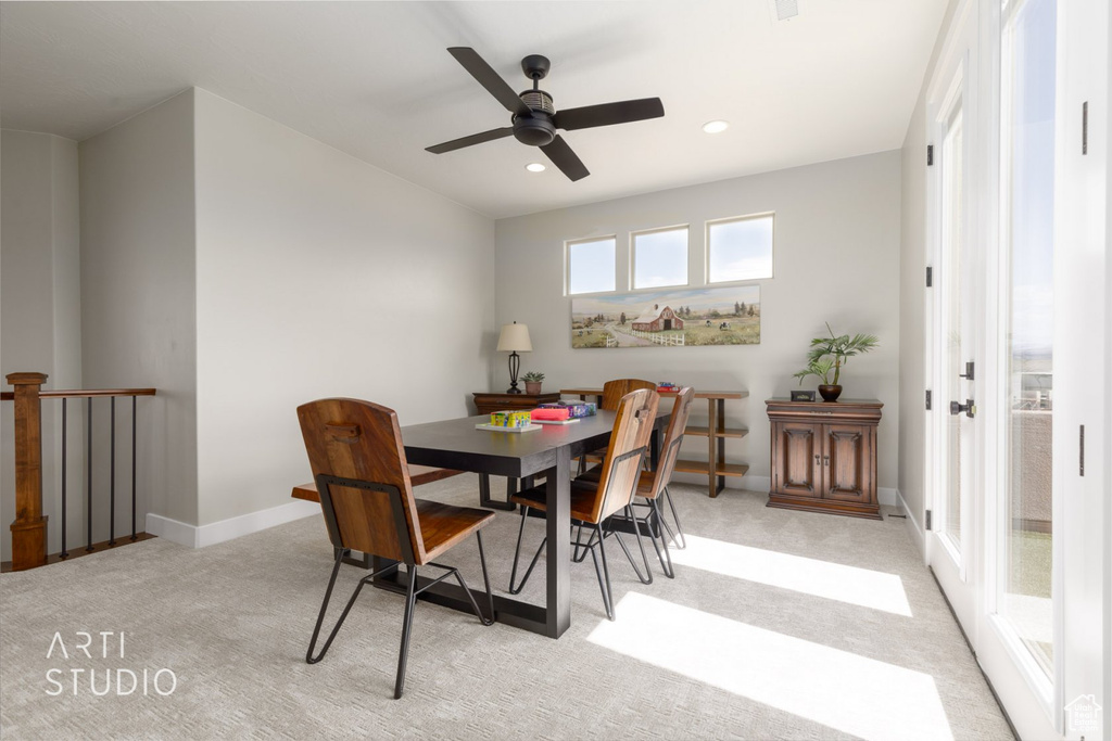 Dining room featuring ceiling fan and light colored carpet
