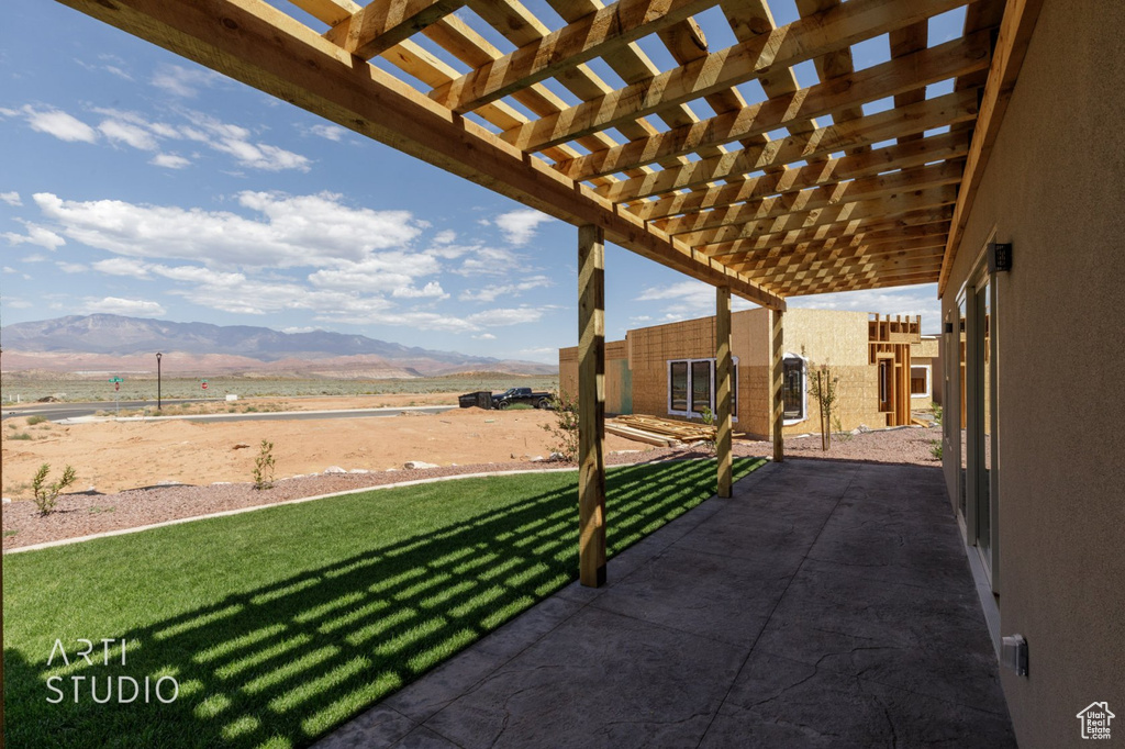View of patio with a mountain view and a pergola