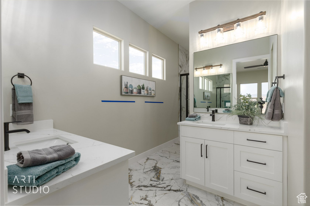 Bathroom featuring double sink vanity and tile floors