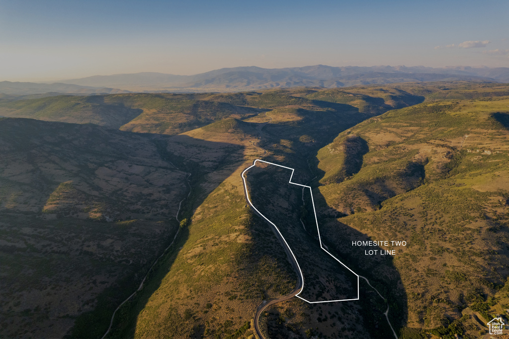 Aerial view of property\'s location featuring property boundaries highlighted and a mountain backdrop