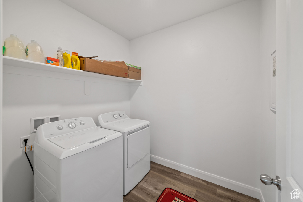 Laundry area featuring hardwood / wood-style floors, washer hookup, and independent washer and dryer