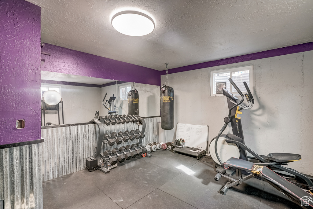Workout room featuring concrete flooring and a textured ceiling