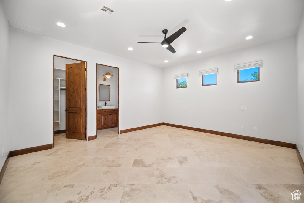 Tiled spare room featuring sink and ceiling fan