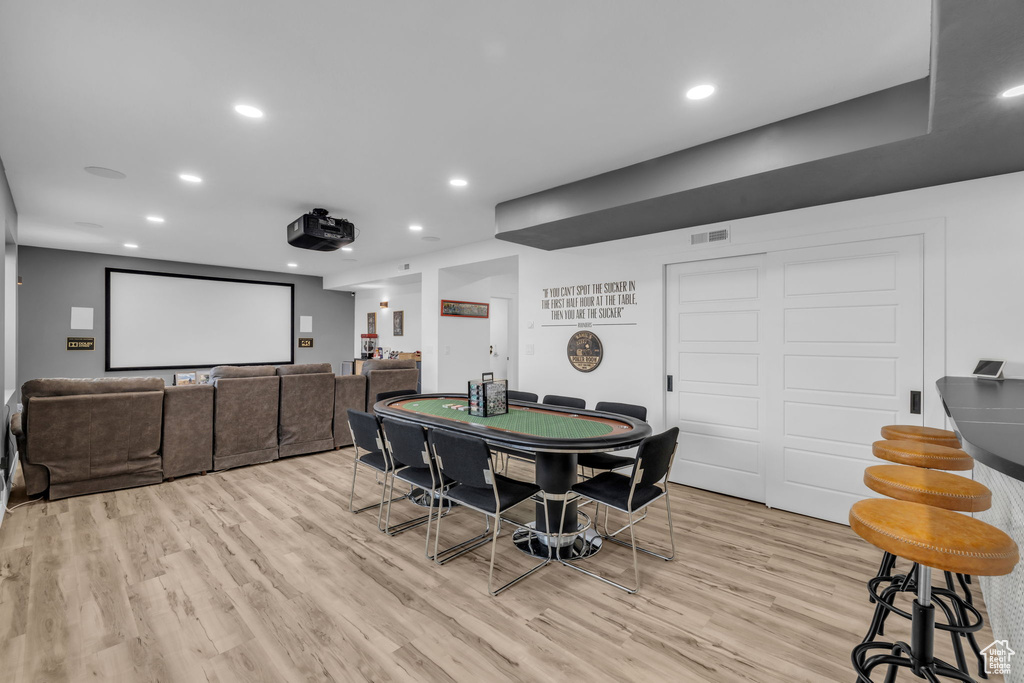 Game room with light hardwood / wood-style flooring