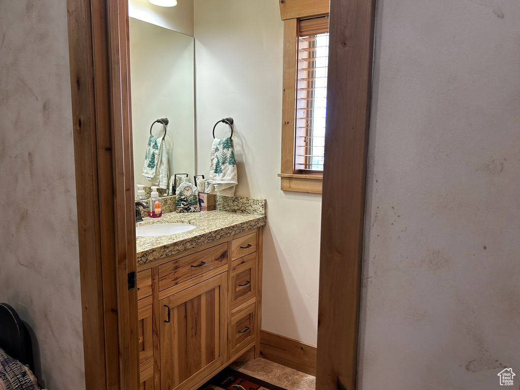 Bathroom with vanity and a healthy amount of sunlight