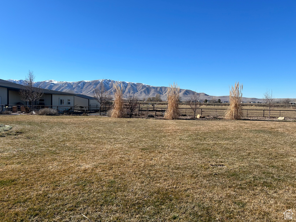 View of yard featuring a rural view and a mountain view