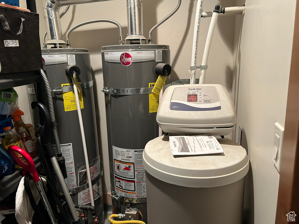 Utility room featuring gas water heater and water heater