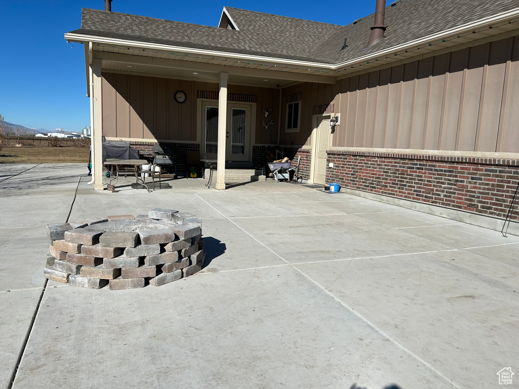 Exterior space featuring a patio and a fire pit