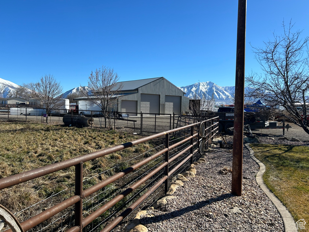 View of yard with a mountain view and a garage