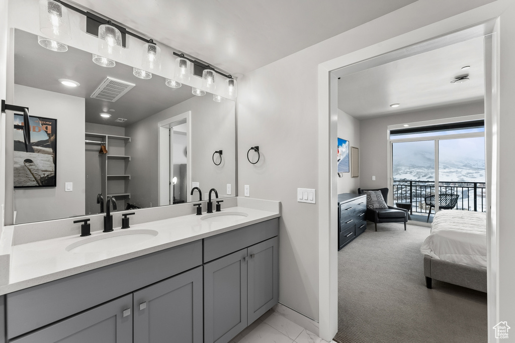 Bathroom with dual sinks, large vanity, and a mountain view