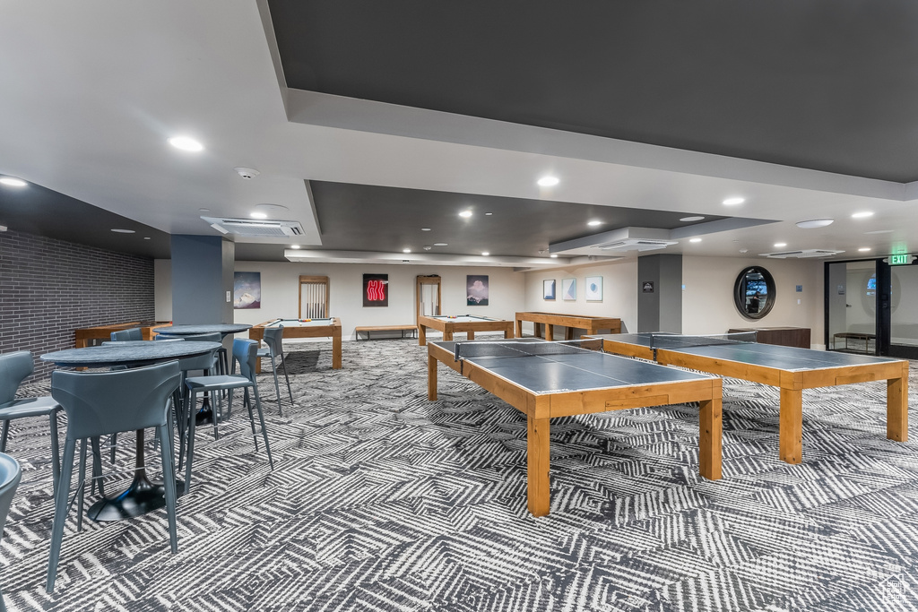 Game room featuring billiards, a raised ceiling, and carpet flooring