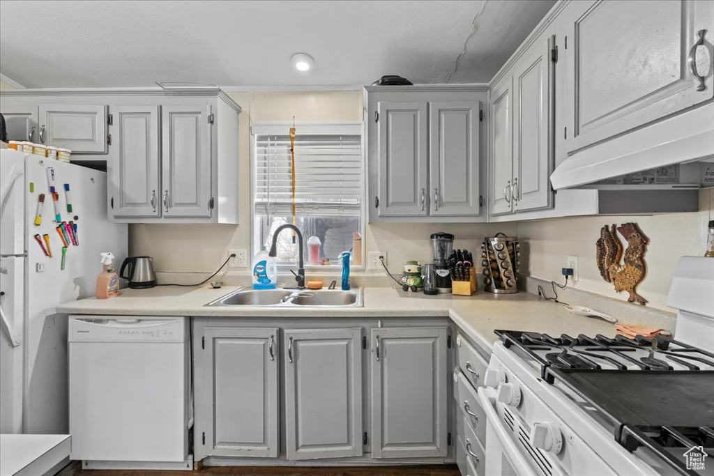 Kitchen featuring white appliances and sink