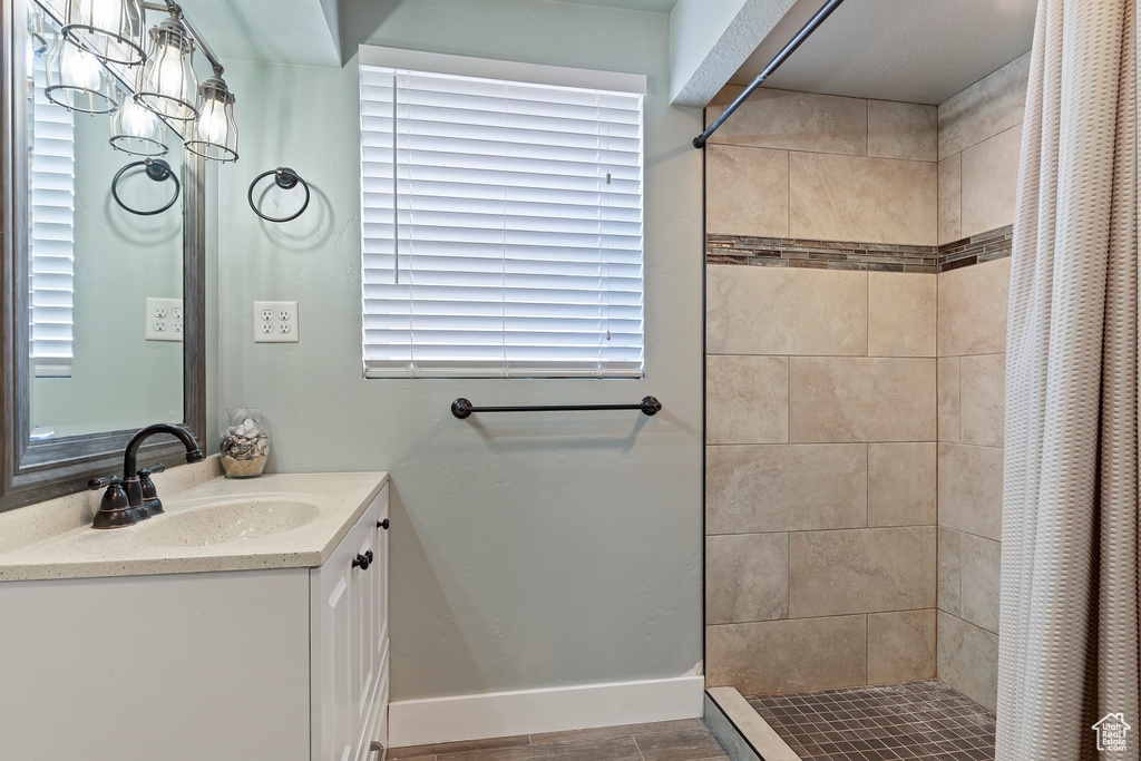 Bathroom featuring vanity, a shower with shower curtain, and tile floors