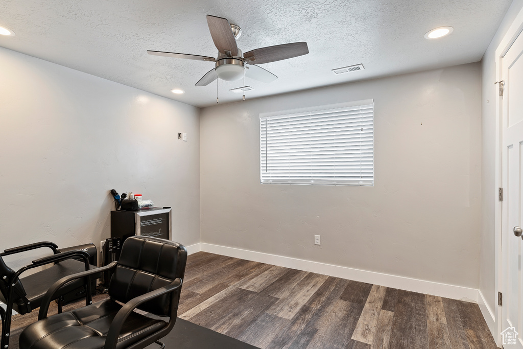 Office featuring dark hardwood / wood-style flooring, ceiling fan, and a textured ceiling