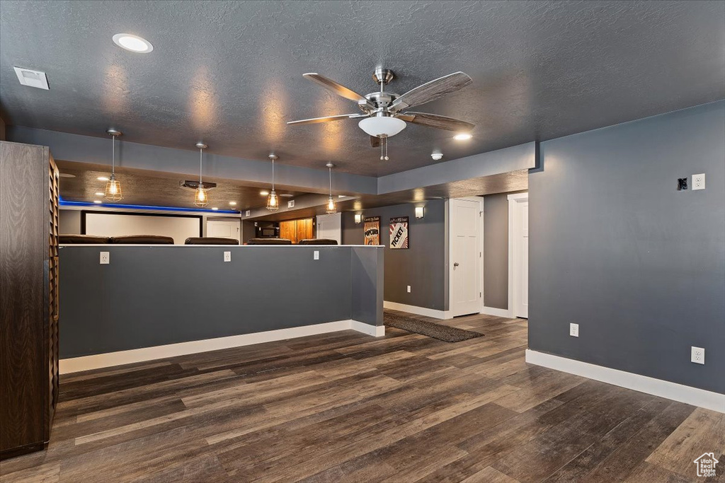 Spare room with dark hardwood / wood-style floors, ceiling fan, and a textured ceiling