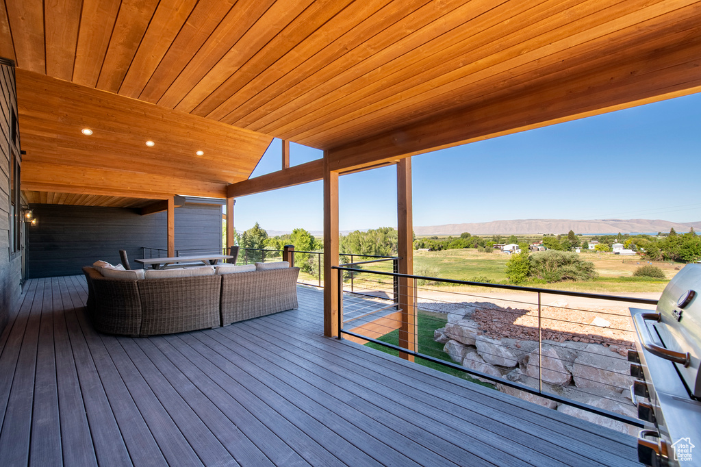 Wooden deck featuring an outdoor living space