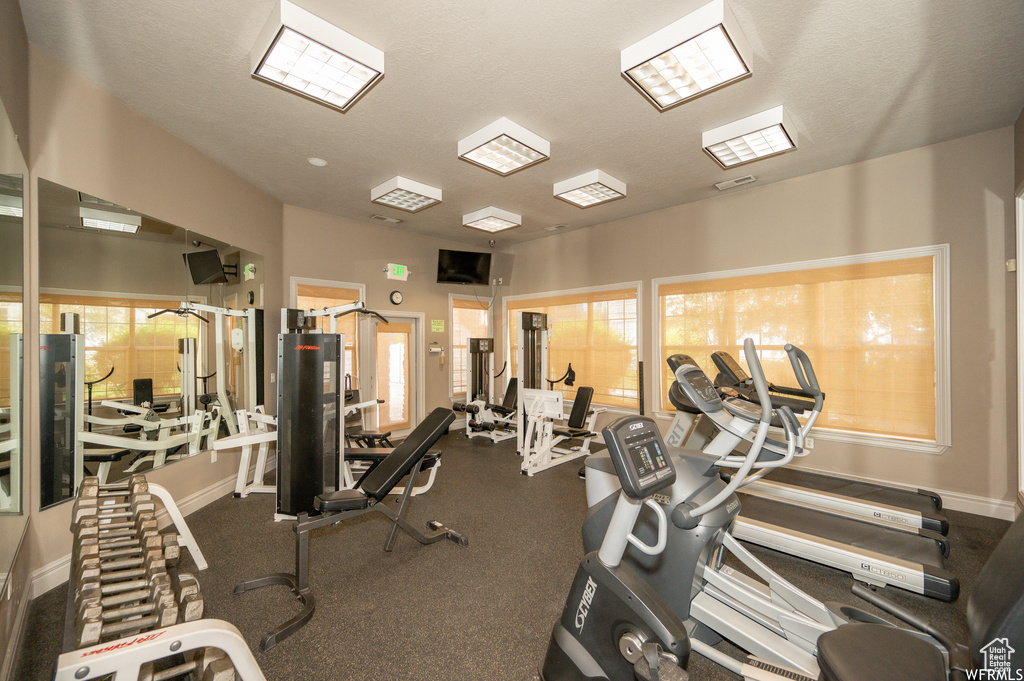 Gym featuring plenty of natural light and a textured ceiling