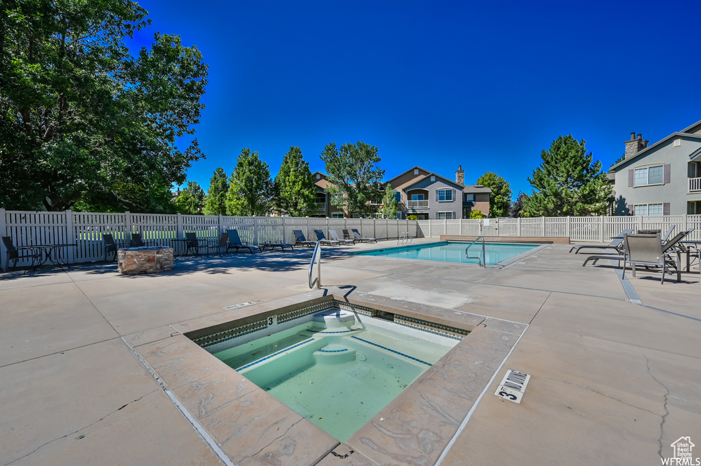 View of swimming pool featuring a patio area and a community hot tub