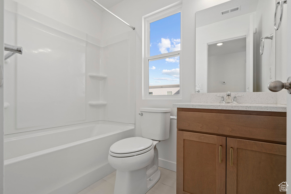 Full bathroom with toilet, shower / tub combination, oversized vanity, and tile flooring