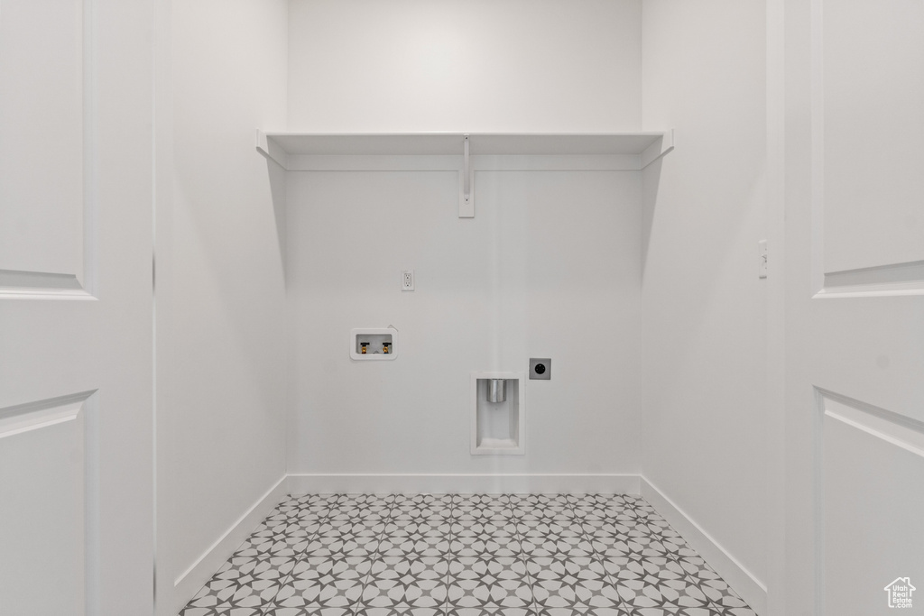 Washroom featuring tile floors, hookup for an electric dryer, and washer hookup