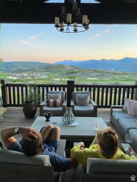 Balcony at dusk with a mountain view and an outdoor hangout area