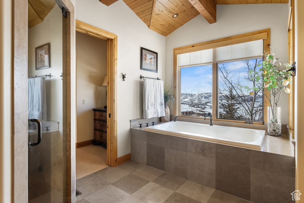 Bathroom featuring vaulted ceiling with beams, independent shower and bath, a mountain view, tile flooring, and wooden ceiling
