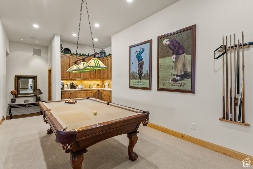 Game room with light carpet, billiards, and indoor bar