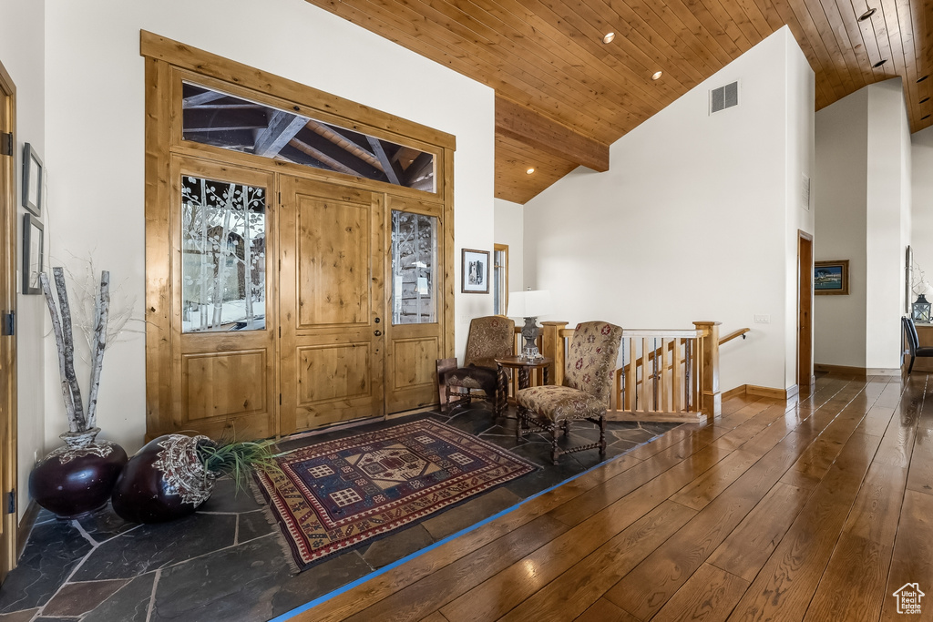 Foyer with dark hardwood / wood-style floors, beam ceiling, wooden ceiling, and high vaulted ceiling