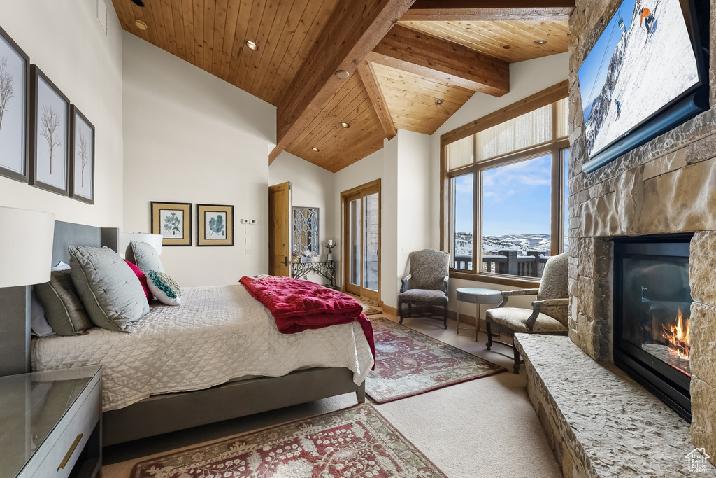 Carpeted bedroom featuring high vaulted ceiling, beam ceiling, and wood ceiling