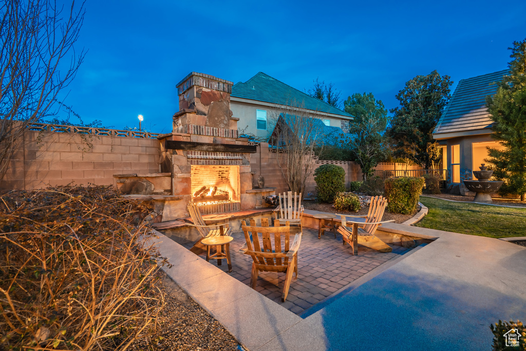View of patio with an outdoor fireplace