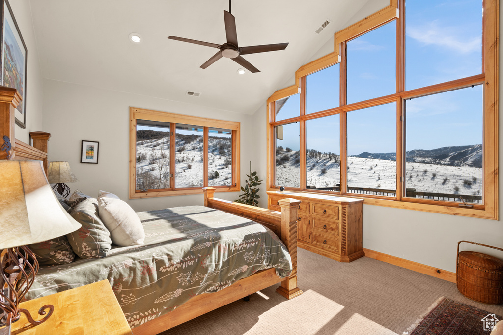 Carpeted bedroom featuring a mountain view, ceiling fan, and high vaulted ceiling