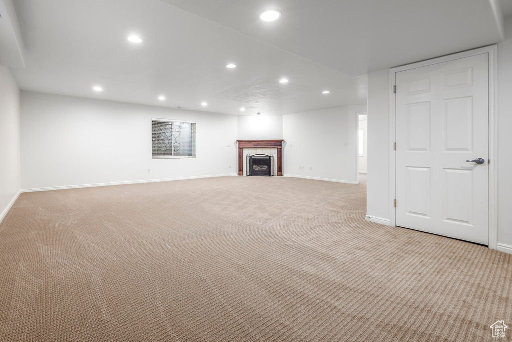 Basement featuring light colored carpet