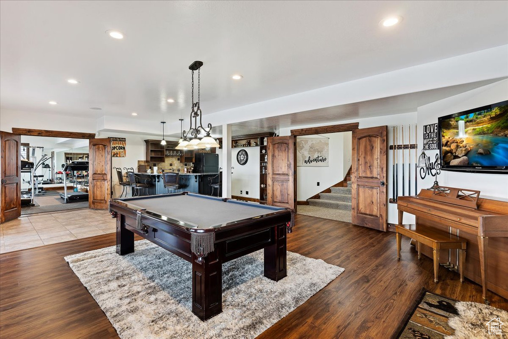 Game room featuring light tile flooring, bar, and billiards