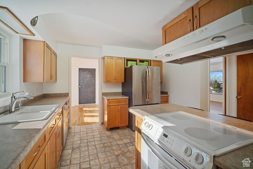 Kitchen featuring light wood-type flooring, appliances with stainless steel finishes, and sink