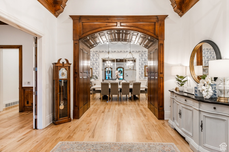 Entryway with a chandelier and light hardwood / wood-style flooring