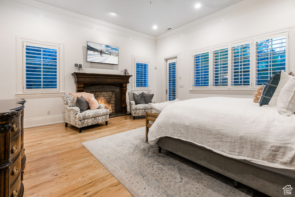 Bedroom featuring light hardwood / wood-style flooring and crown molding