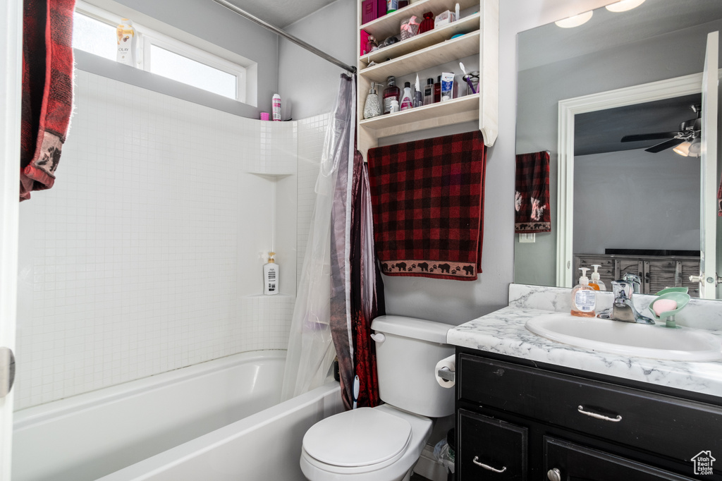 Full bathroom featuring vanity, shower / bath combo, ceiling fan, and toilet