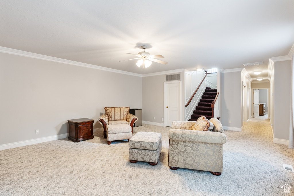 Sitting room with crown molding, ceiling fan, and light carpet