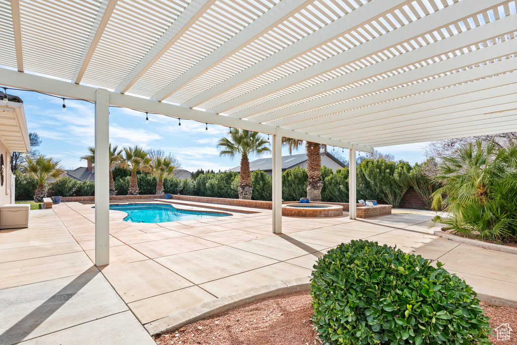 View of pool featuring a patio area and a pergola