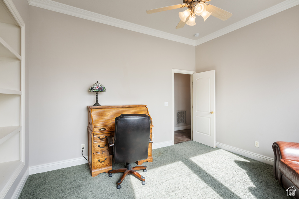 Carpeted office featuring ceiling fan and ornamental molding