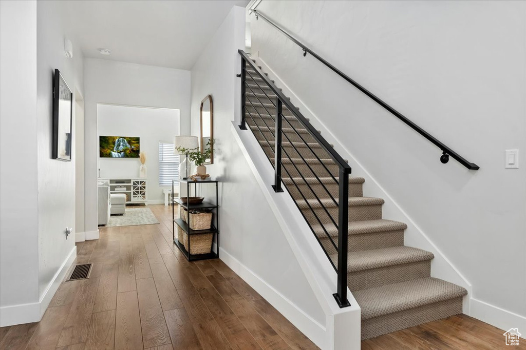 Stairs with hardwood / wood-style flooring