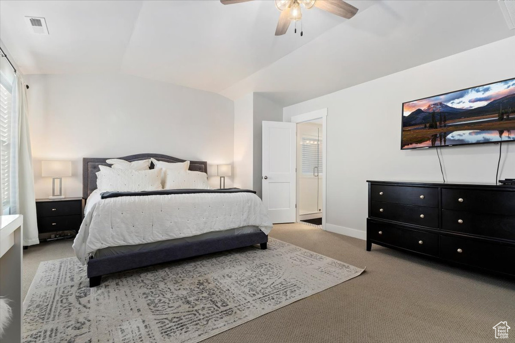 Bedroom featuring ceiling fan, light colored carpet, and vaulted ceiling